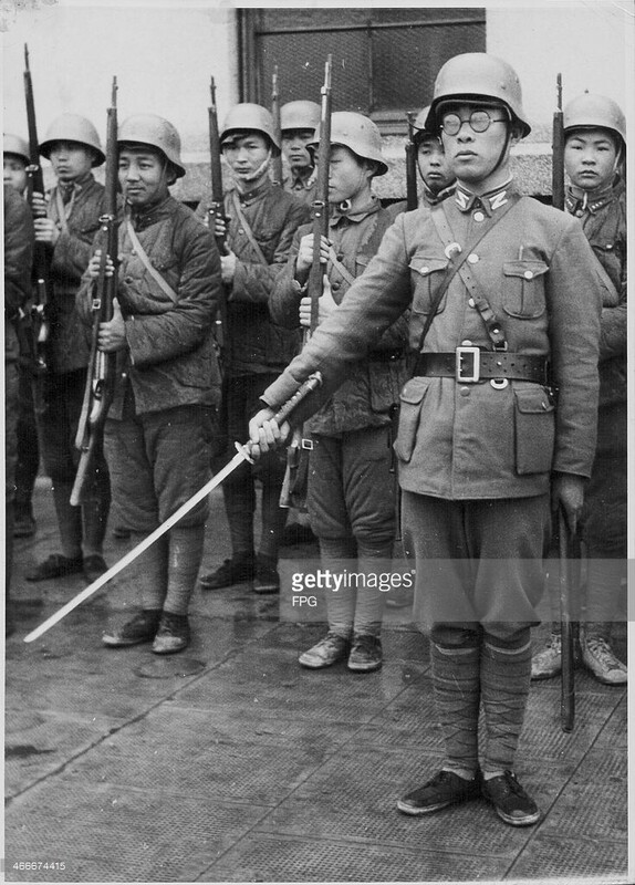 Japanese Ta-Tao troops, criminals and youngsters making up an untrained military, in formation behind an officer with a Samurai sword, World War Two, Japan, circa 1939-1945..jpg